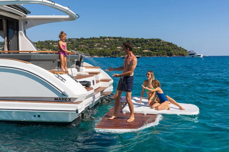  Yacht Photos Pics Family enjoying water activities on a 2026 Marex 440 Gourmet Cruiser yacht.