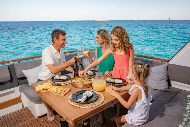  Yacht Photos Pics Family dining on Marex 440 Gourmet Cruiser, 2026, enjoying a meal with ocean view.