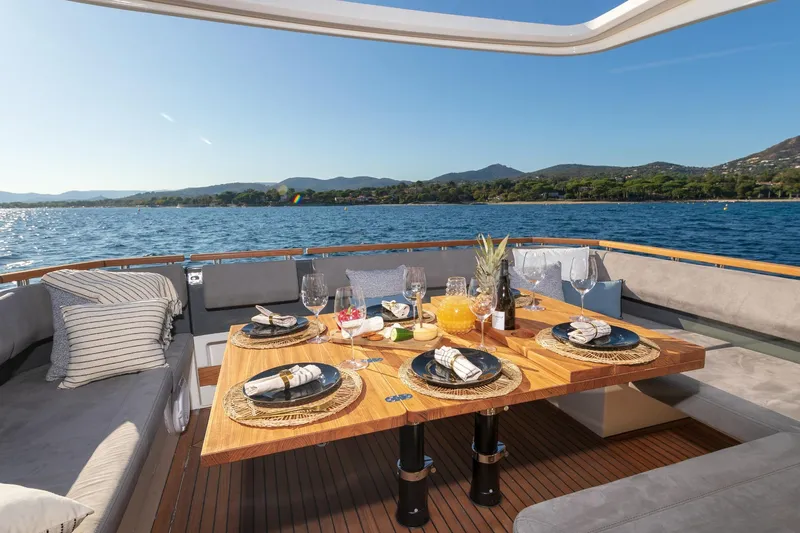  Yacht Photos Pics Luxurious dining setup on 2026 Marex 440 Gourmet Cruiser yacht, with scenic ocean view.