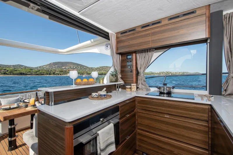  Yacht Photos Pics Luxurious kitchen interior of 2026 Marex 440 Gourmet Cruiser with scenic ocean view.