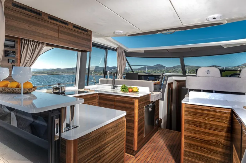  Yacht Photos Pics Luxurious interior of 2026 Marex 440 Gourmet Cruiser with modern kitchen and scenic views.