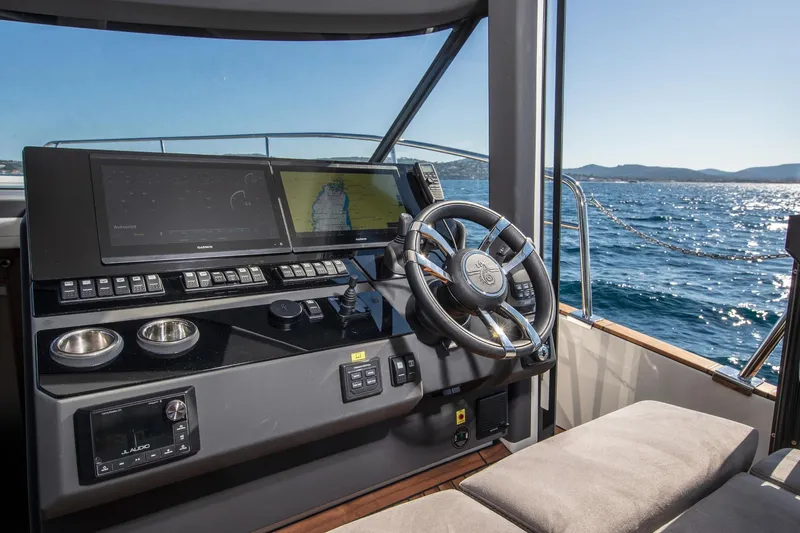  Yacht Photos Pics Helm of 2026 Marex 440 Gourmet Cruiser with navigation screens and steering wheel.