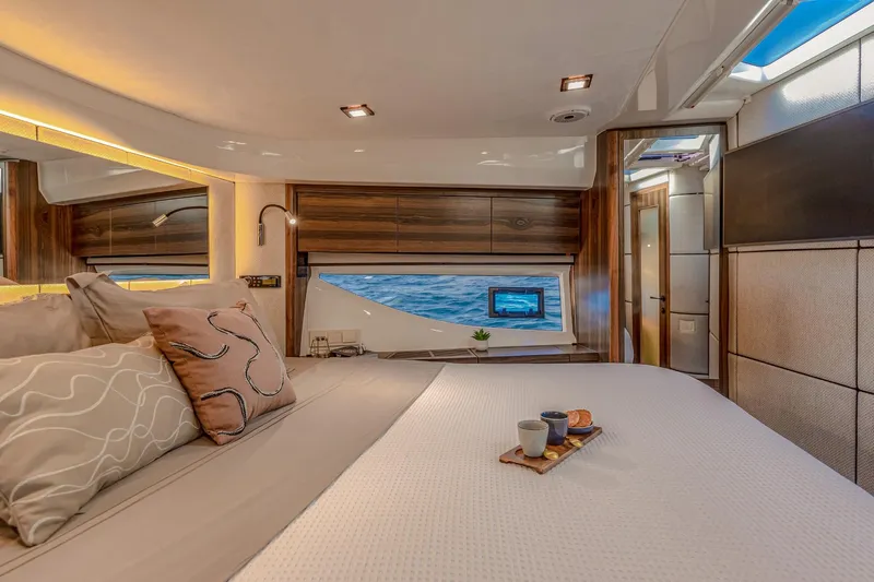  Yacht Photos Pics Luxurious interior of 2026 Marex 440 Gourmet Cruiser with ocean view and elegant bedding.