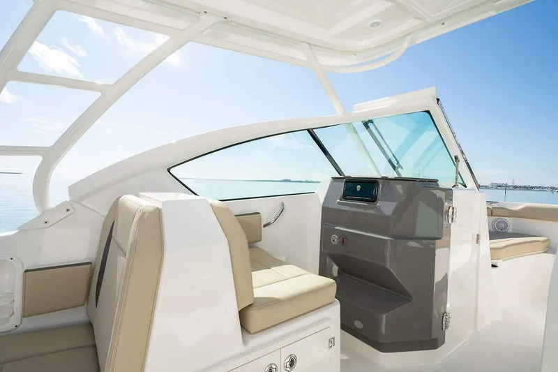 T/t Lucky Seven Yacht Photos Pics Manufacturer Provided Image: 2022 Pursuit DC 266 Dual Console boat interior with beige seating and modern dashboard.