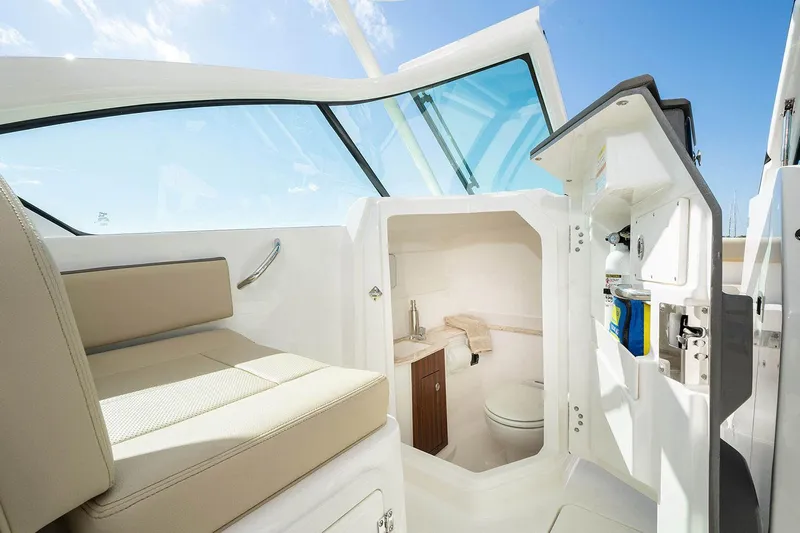 T/t Lucky Seven Yacht Photos Pics Manufacturer Provided Image: 2022 Pursuit DC 266 Dual Console boat interior with a compact bathroom.