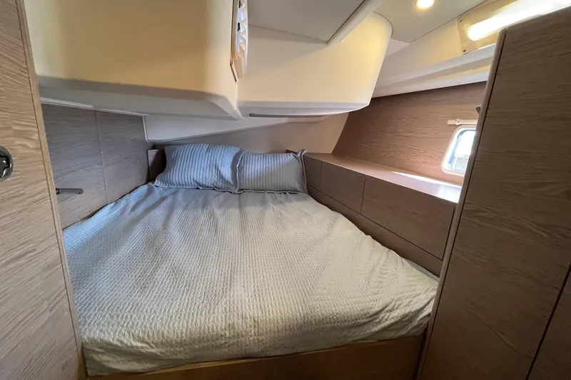 Eto Mio Yacht Photos Pics Cozy bedroom interior of 2021 Hanse 508 yacht with modern wood finish and soft lighting.