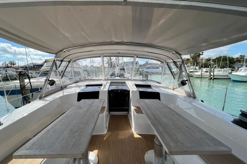 Eto Mio Yacht Photos Pics Spacious cockpit of 2021 Hanse 508 yacht with wooden tables and marina view.