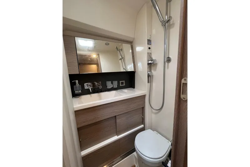 Eto Mio Yacht Photos Pics Modern bathroom in 2021 Hanse 508 yacht with shower, sink, and toilet.
