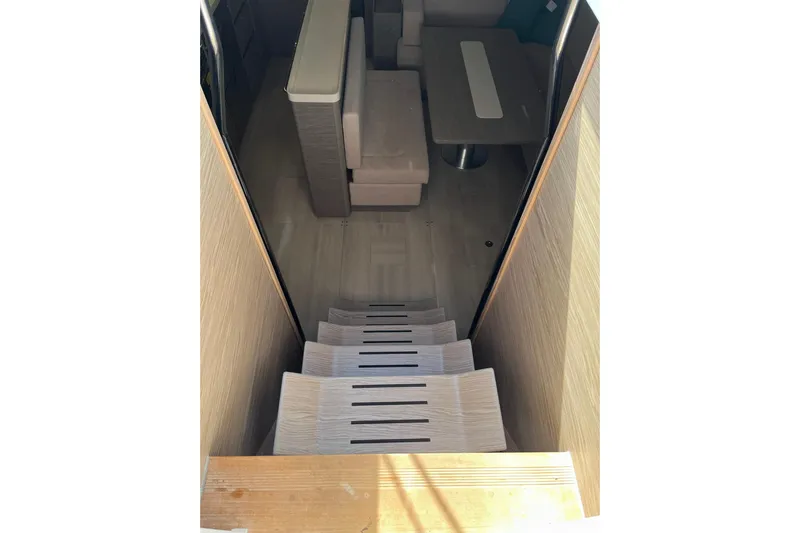 Eto Mio Yacht Photos Pics Interior view of 2021 Hanse 508 yacht, featuring stairs and a cozy seating area.