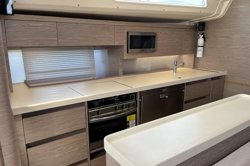 Eto Mio Yacht Photos Pics Modern kitchen interior of 2021 Hanse 508 yacht with sleek cabinetry and appliances.