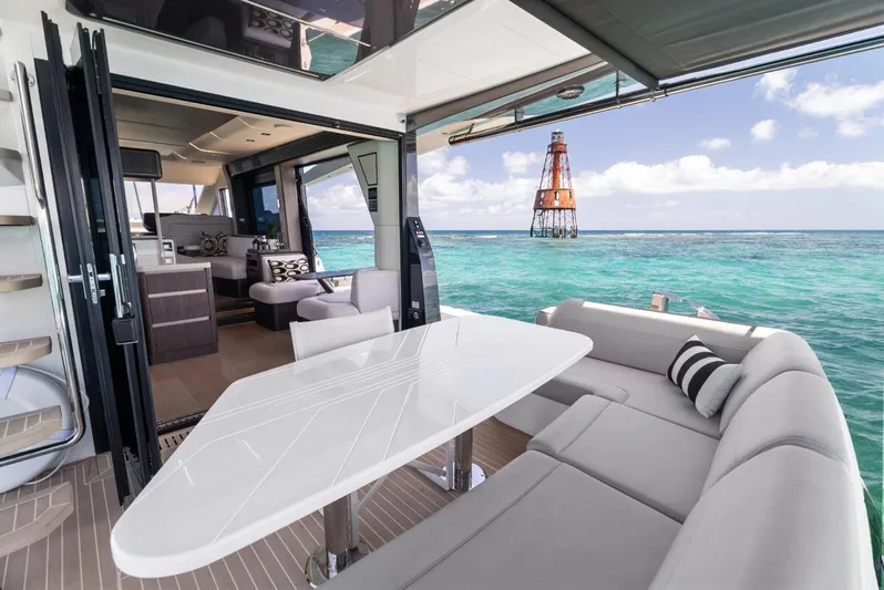 Dad Bod Yacht Photos Pics Luxurious 2024 Galeon 560 Fly yacht interior with ocean view and lighthouse in the background.