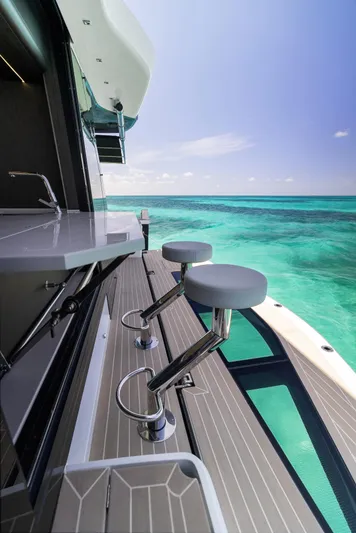 Dad Bod Yacht Photos Pics 2024 Galeon 560 Fly yacht with bar stools overlooking turquoise ocean waters.