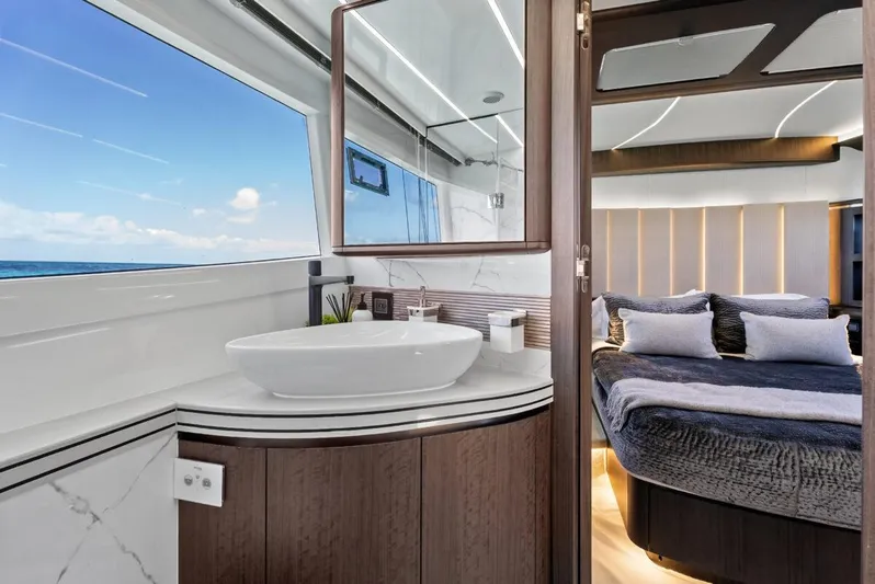 Dad Bod Yacht Photos Pics Luxurious interior of 2024 Galeon 560 Fly yacht with modern bathroom and cozy bedroom.