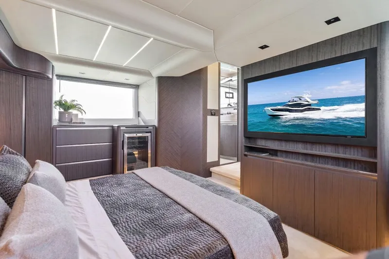 Dad Bod Yacht Photos Pics Luxurious interior of 2024 Galeon 560 Fly yacht with modern bedroom and large TV.