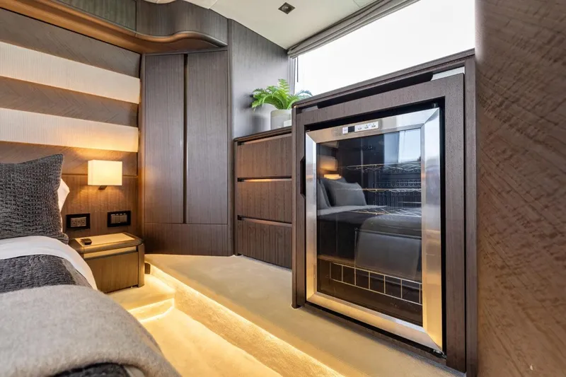 Dad Bod Yacht Photos Pics Luxurious interior of 2024 Galeon 560 Fly yacht with modern furnishings and mini fridge.