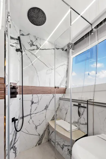 Dad Bod Yacht Photos Pics Luxurious bathroom in 2024 Galeon 560 Fly yacht with marble walls and modern shower.