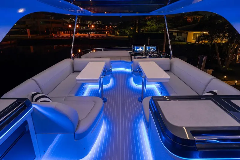 Dad Bod Yacht Photos Pics Luxurious 2024 Galeon 560 Fly yacht interior with ambient blue lighting and modern seating.