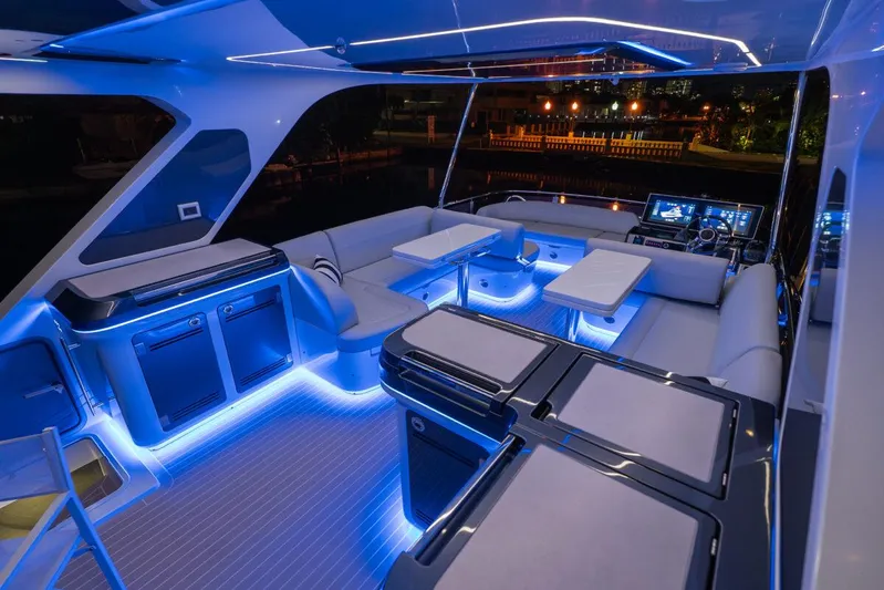 Dad Bod Yacht Photos Pics Luxurious 2024 Galeon 560 Fly yacht interior with ambient blue lighting and modern seating.