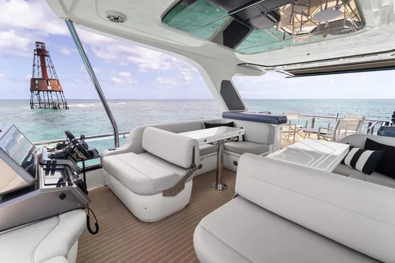Dad Bod Yacht Photos Pics Luxurious 2024 Galeon 560 Fly yacht interior with ocean view and lighthouse in background.