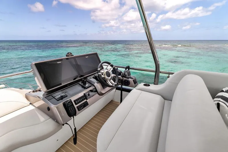 Dad Bod Yacht Photos Pics 2024 Galeon 560 Fly yacht helm with ocean view, featuring modern navigation equipment.