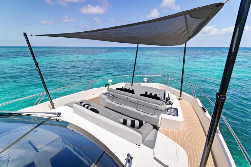 Dad Bod Yacht Photos Pics 2024 Galeon 560 Fly yacht deck with sunshade, overlooking turquoise ocean waters.