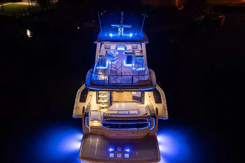 Dad Bod Yacht Photos Pics 2024 Galeon 560 Fly yacht illuminated with blue lights at night.
