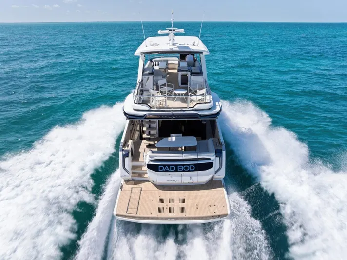 Dad Bod Yacht Photos Pics 2024 Galeon 560 Fly yacht cruising on open sea, rear view.