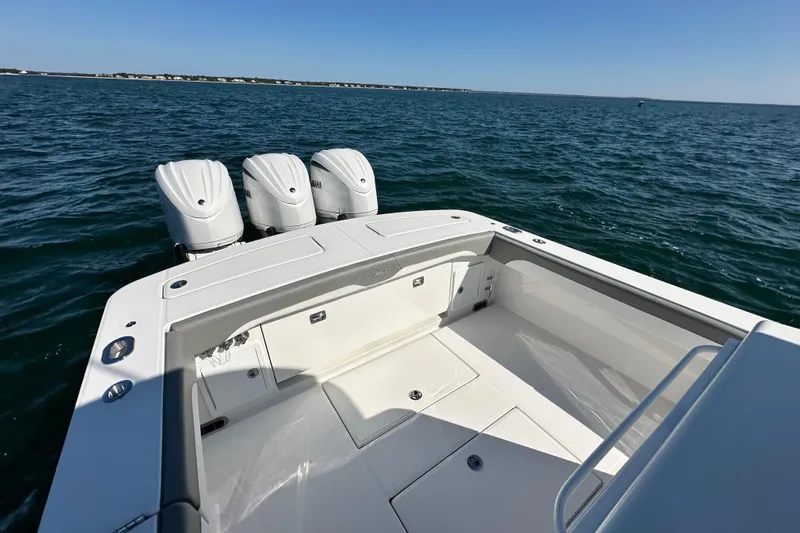 Shark Gray Yacht Photos Pics 2024 Regulator 34 boat with triple engines on open water.