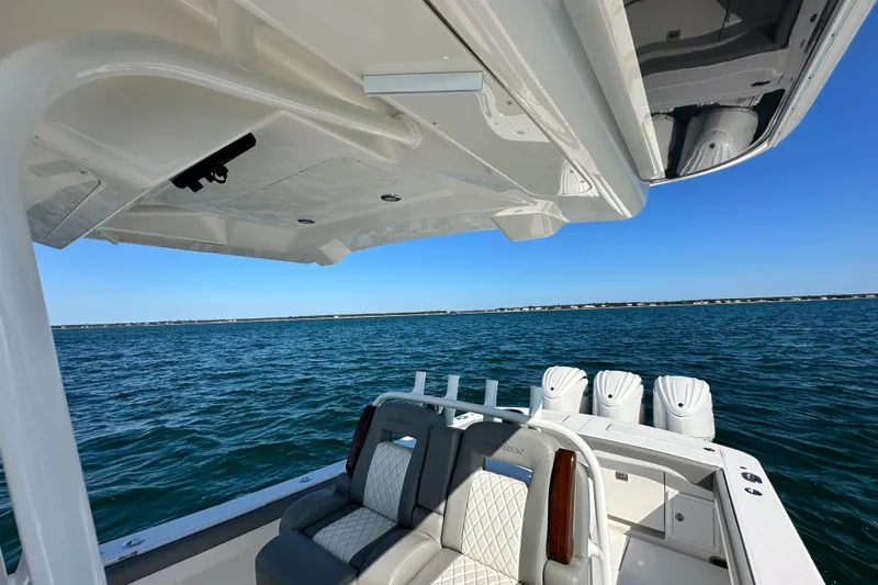 Shark Gray Yacht Photos Pics 2024 Regulator 34 boat interior with ocean view, featuring luxurious seating and multiple engines.