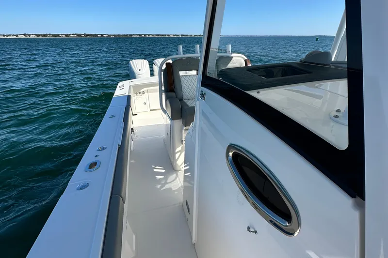 Shark Gray Yacht Photos Pics 2024 Regulator 34 boat on water, showcasing sleek design and spacious deck.