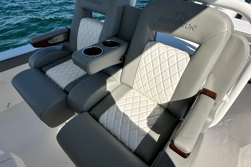 Shark Gray Yacht Photos Pics Luxurious seating on 2024 Regulator 34 boat with quilted upholstery and cup holders.