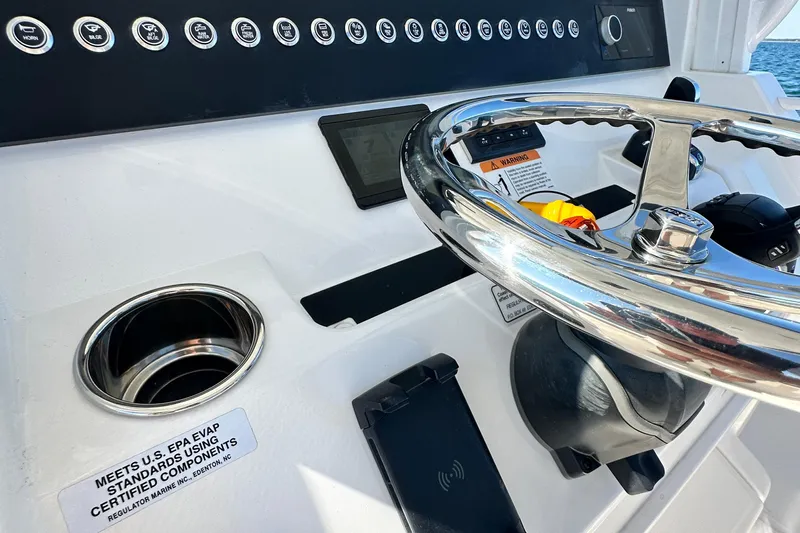 Shark Gray Yacht Photos Pics 2024 Regulator 34 boat helm with steering wheel and control panel.
