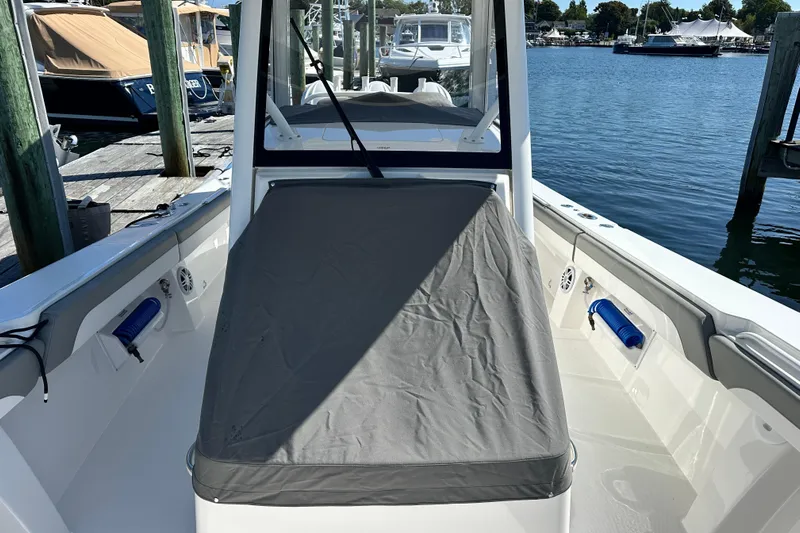 Shark Gray Yacht Photos Pics 2024 Regulator 34 boat docked, featuring a covered seating area and sleek design.