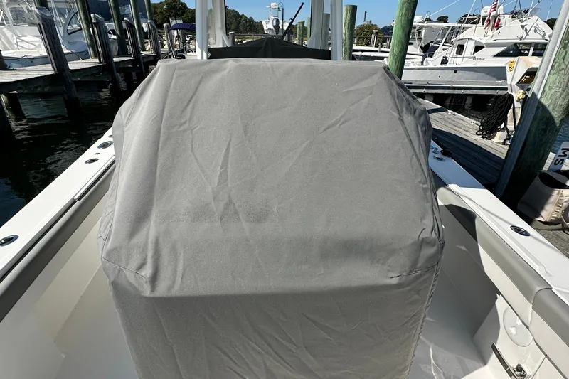 Shark Gray Yacht Photos Pics 2024 Regulator 34 boat console covered with a protective gray cover at a marina.
