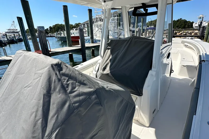 Shark Gray Yacht Photos Pics 2024 Regulator 34 boat interior at marina, covered seats, sunny day.
