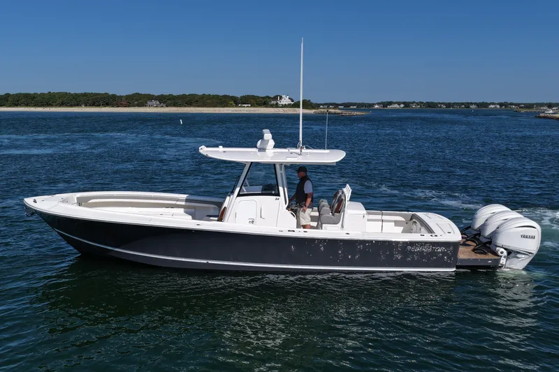 Shark Gray Yacht Photos Pics 2024 Regulator 34 boat cruising on open water with clear blue sky.
