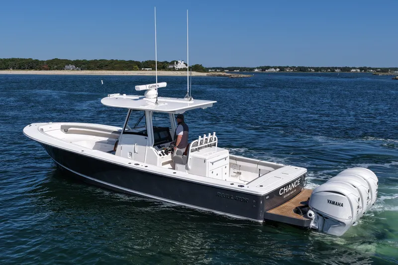 Shark Gray Yacht Photos Pics 2024 Regulator 34 boat cruising on water with Yamaha engines, featuring sleek design.