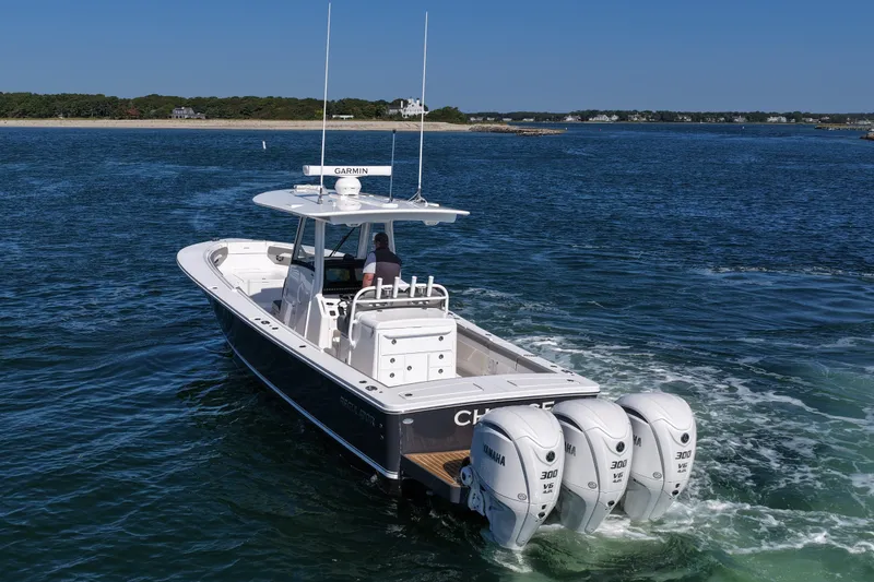 Shark Gray Yacht Photos Pics 2024 Regulator 34 boat with triple Yamaha engines cruising on open water.