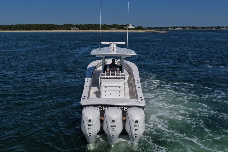 Shark Gray Yacht Photos Pics 2024 Regulator 34 boat cruising on open water with triple 300 horsepower engines.