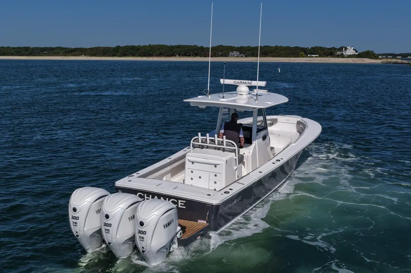 Shark Gray Yacht Photos Pics 2024 Regulator 34 boat with triple Yamaha engines cruising on open water.