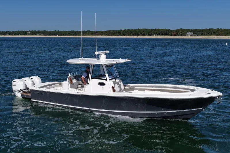 Shark Gray Yacht Photos Pics 2024 Regulator 34 boat cruising on open water, featuring sleek design and powerful engines.
