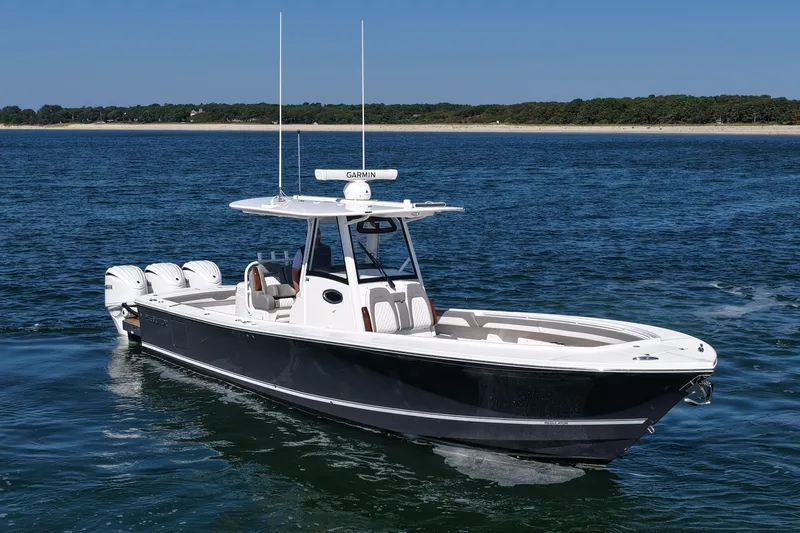 Shark Gray Yacht Photos Pics 2024 Regulator 34 boat cruising on open water with clear blue sky.