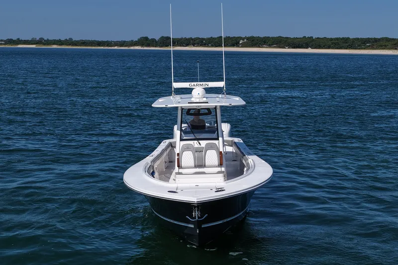 Shark Gray Yacht Photos Pics 2024 Regulator 34 boat on calm water, featuring Garmin equipment.