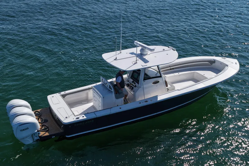 Shark Gray Yacht Photos Pics 2024 Regulator 34 boat on open water, featuring triple Yamaha engines.