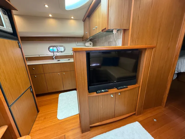  Yacht Photos Pics Interior of 2014 Tiara Yachts 4500 Sovran with wood cabinetry and TV.