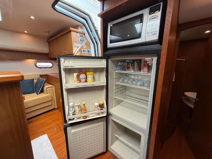  Yacht Photos Pics 2014 Tiara Yachts 4500 Sovran interior with open fridge and microwave.