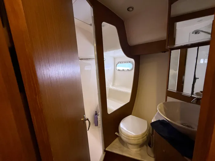  Yacht Photos Pics 2014 Tiara Yachts 4500 Sovran bathroom with modern fixtures and porthole window.