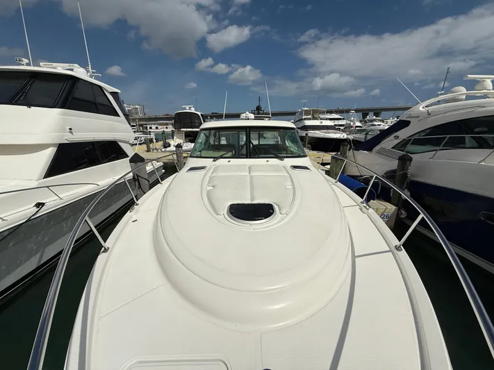  Yacht Photos Pics 2014 Tiara Yachts 4500 Sovran docked among other boats under a partly cloudy sky.