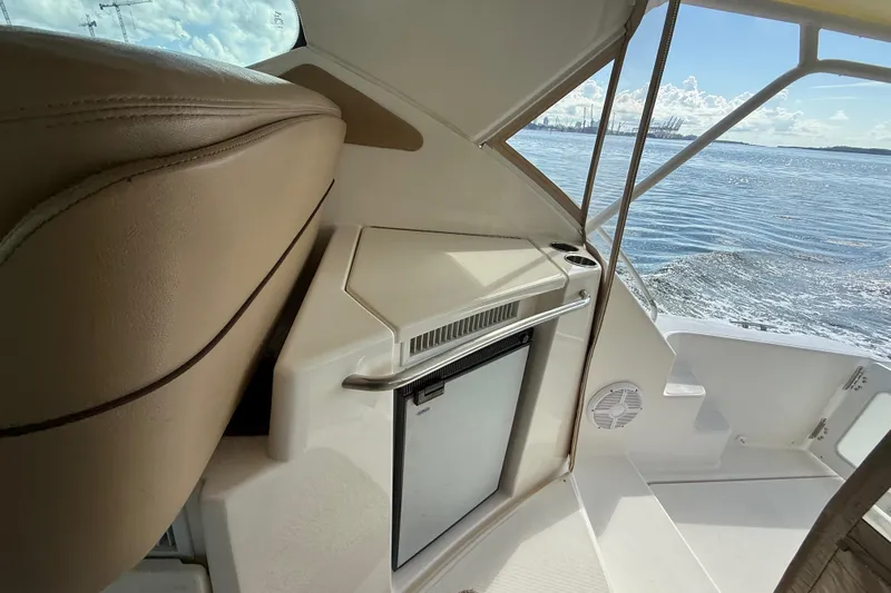  Yacht Photos Pics Interior view of 2014 Tiara Yachts 4500 Sovran, featuring a compact fridge and seating.