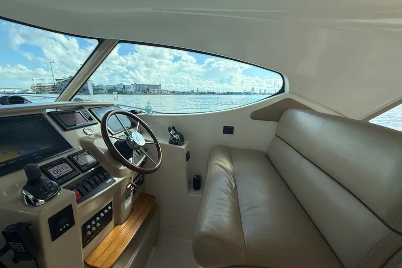  Yacht Photos Pics Interior of 2014 Tiara Yachts 4500 Sovran, featuring helm and leather seating with waterfront view.